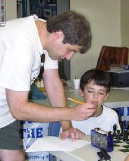 Yury Shulman instructs student at chess camp